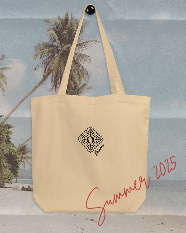 Recycled sustainable beige cotton tote bag, hung up with a beach background