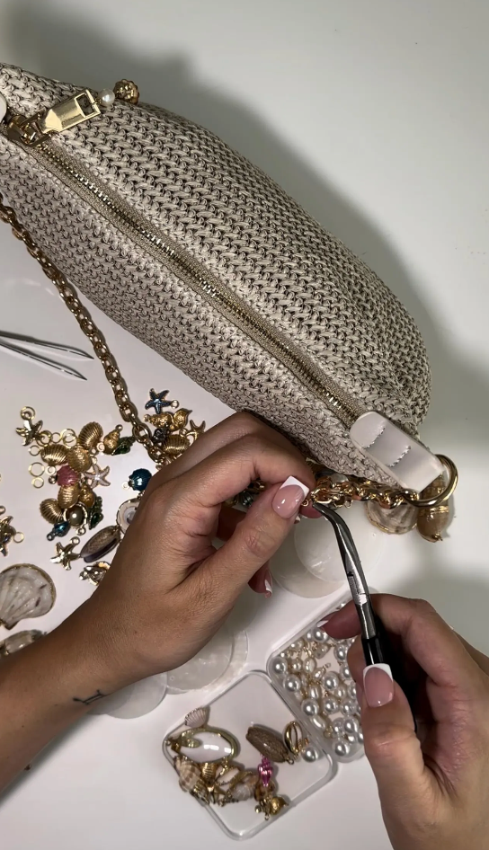 Handmade gold beige chain shell bag with pearls, seen being made on a table