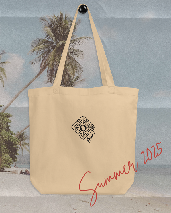 Recycled sustainable beige cotton tote bag, hung up with a beach background 