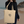 Recycled sustainable beige cotton tote bag, carried by a woman at the beach 