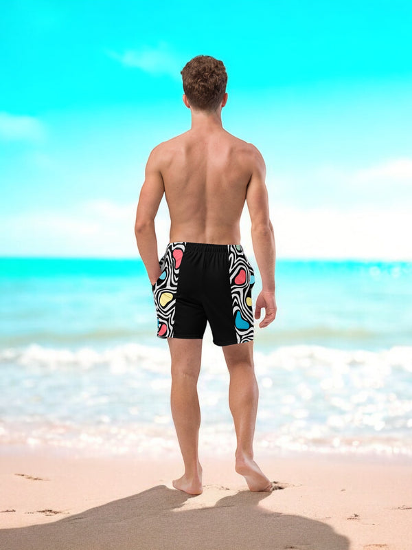 Aurora daze mens swimshorts swimtrunks for men oumaima swim recycled mens boardshorts abract colorful print digital print, seen from the back on a male model stood on a beach