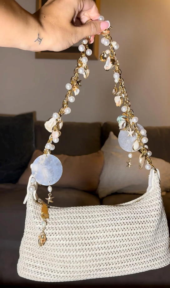 Gold chain handbag with pearls and shells charms sparkling beach bag for evenings and the beach, seen full size hanging 